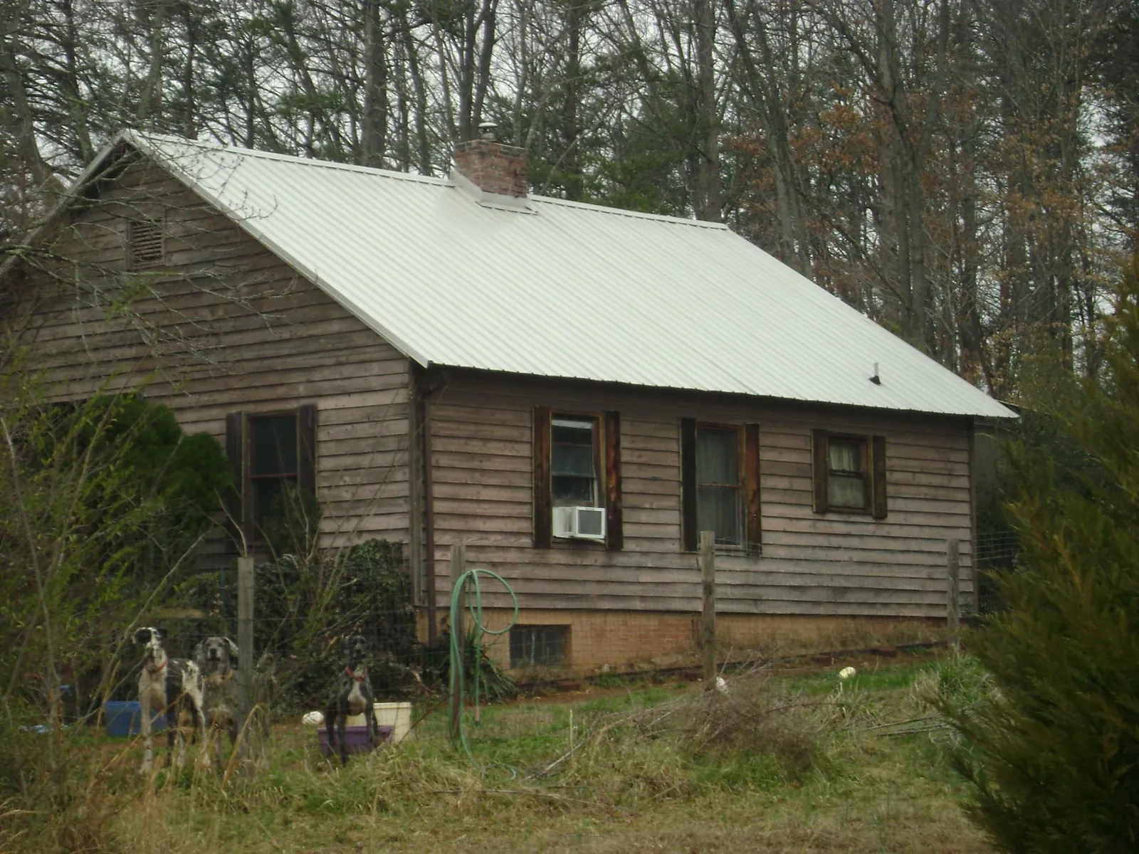 White metal roof on an old wood sided farmhouse, from a Metal Roof Installation job in West Harrison